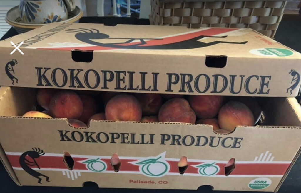 box of peaches with kokopelli produce listed on box