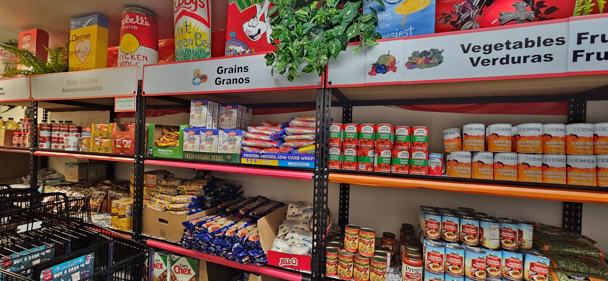 shelves of cans of vegetables and packages of grain at food pantry